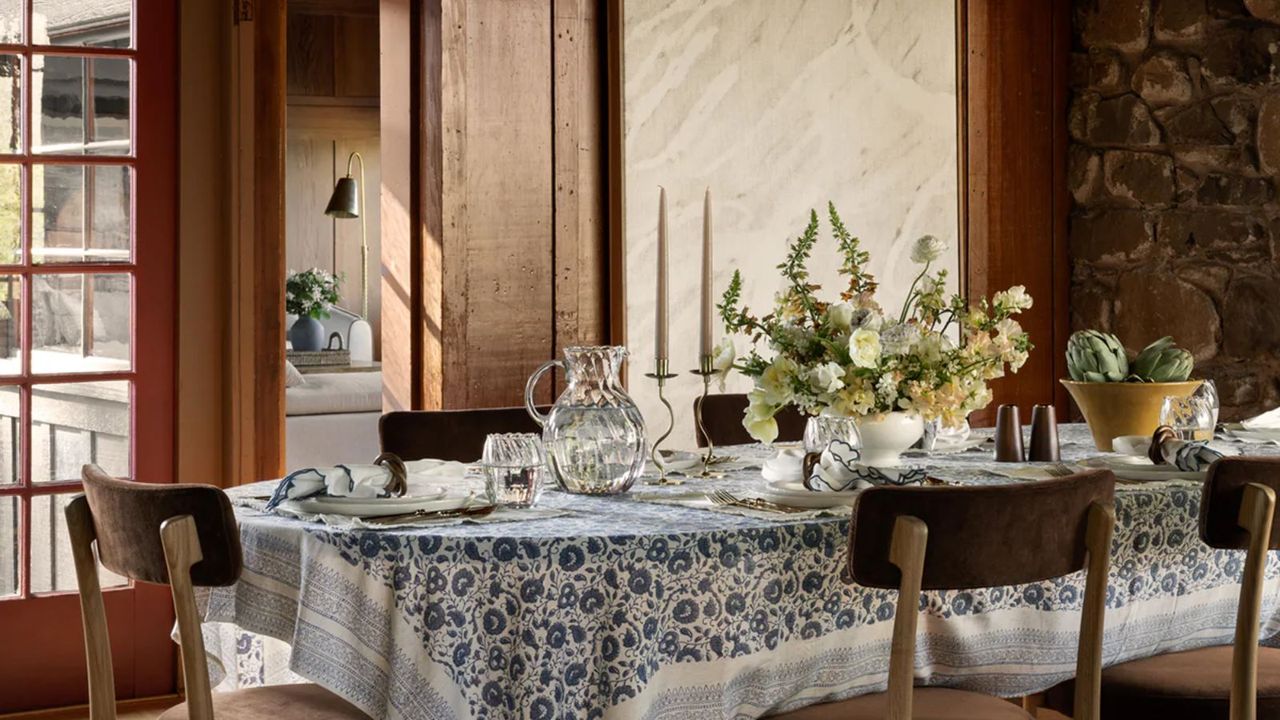 Spring tablescape with blue and white patterned tablecloth, green and yellow flowers