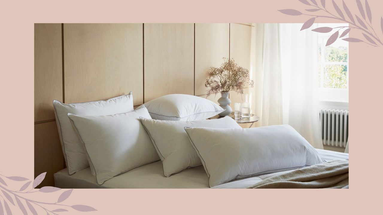 A bed with white bedding in a pink framed border to support an article to support how often should change your pillows