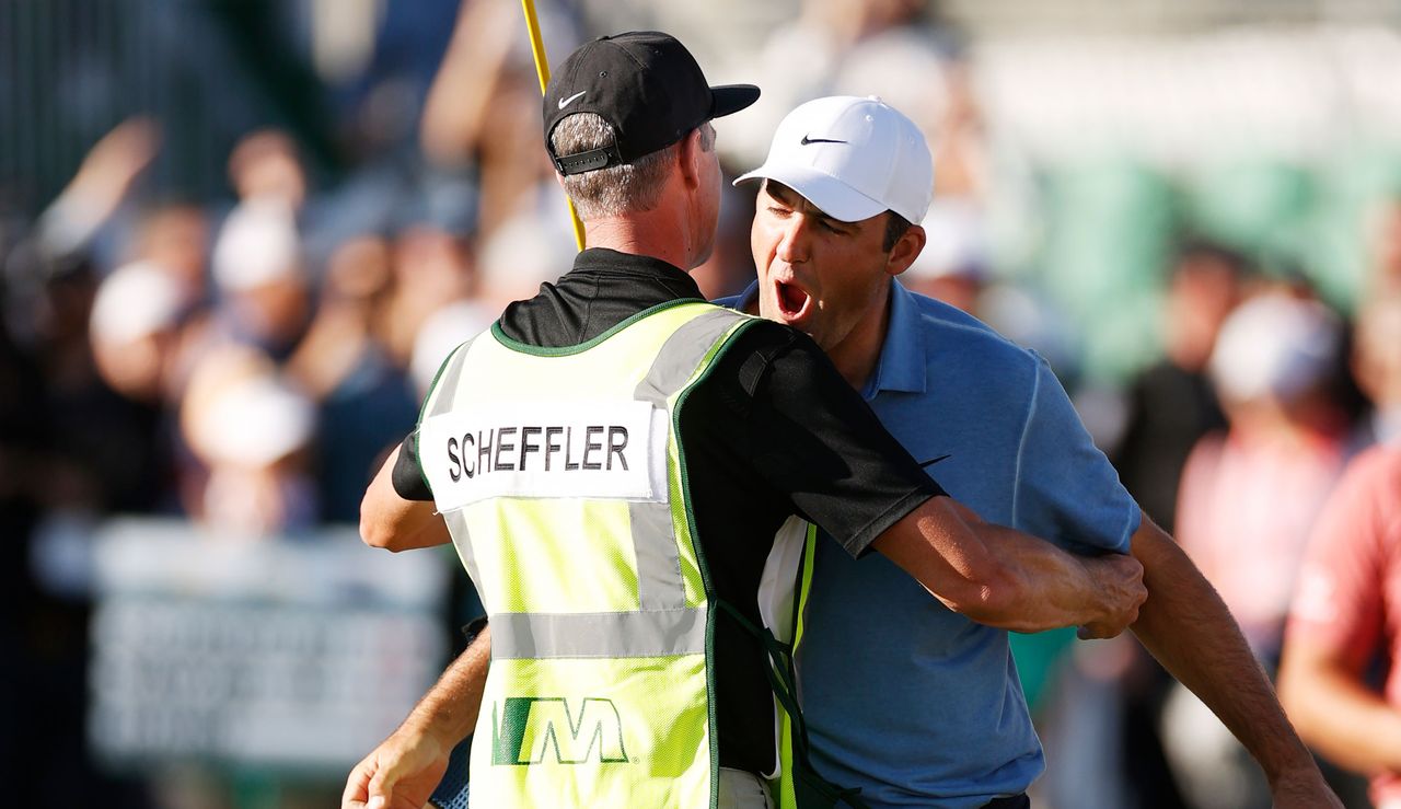 Scheffler hugs his caddie as he celebrates his victory