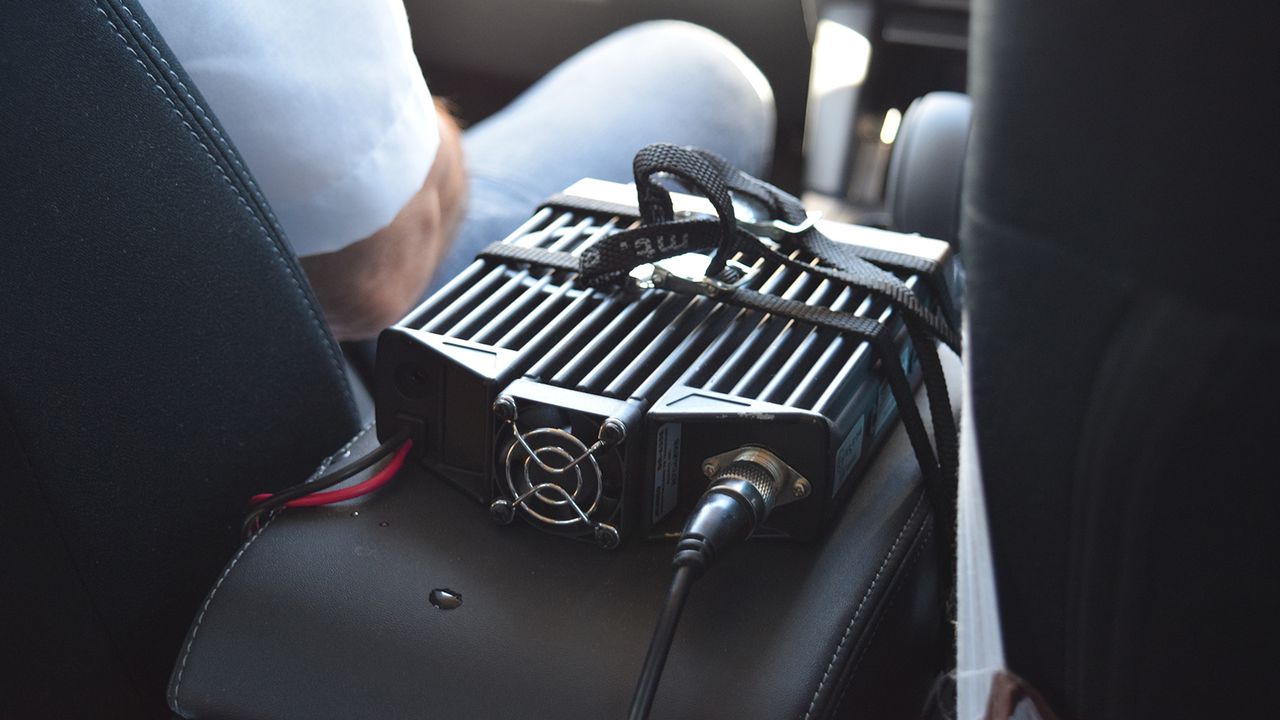 The race radio is attached to the centre console via some toe straps