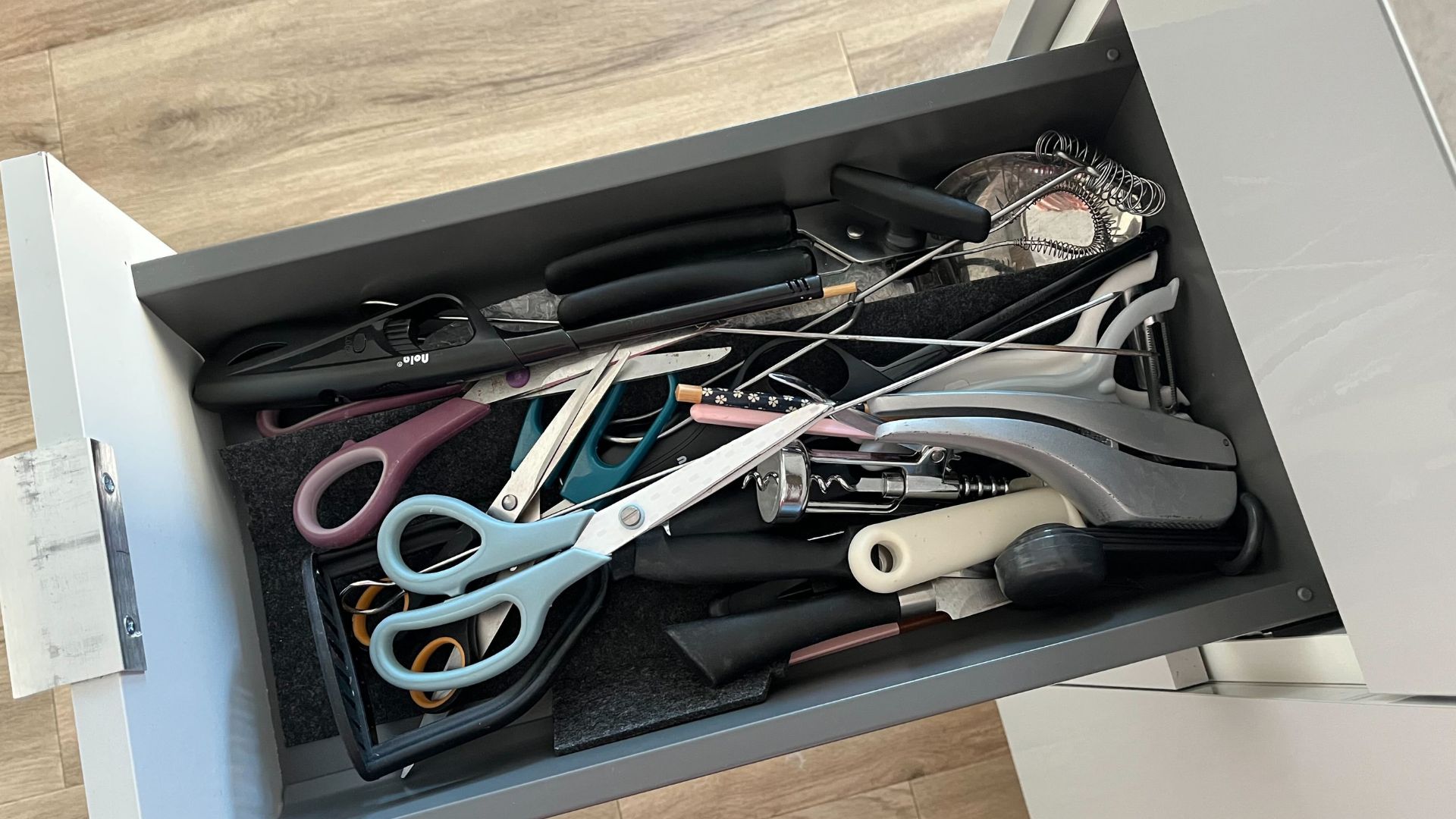 picture of my kitchen drawer with messy utensils