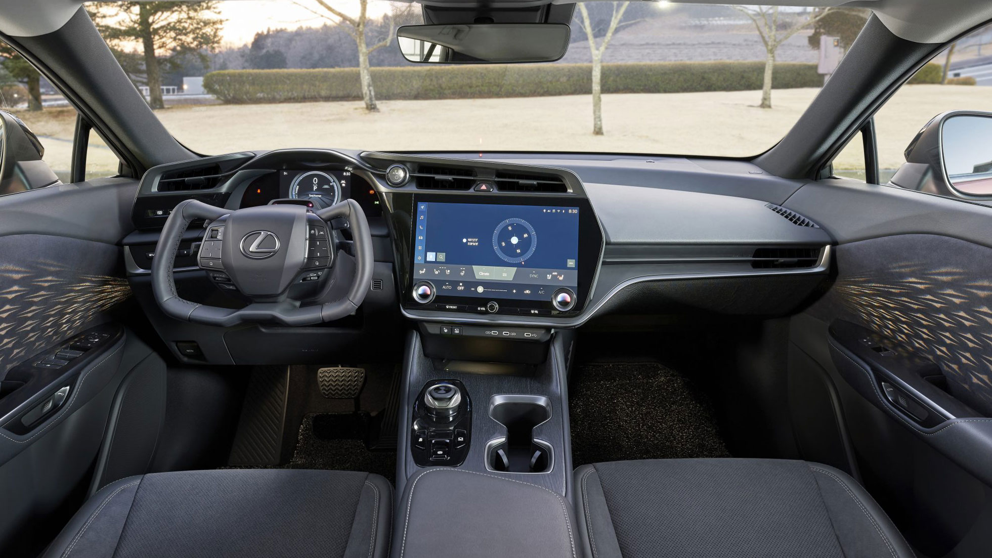 Full width view of dashboard inside Lexus RZ 450e caliper steering wheel closeup