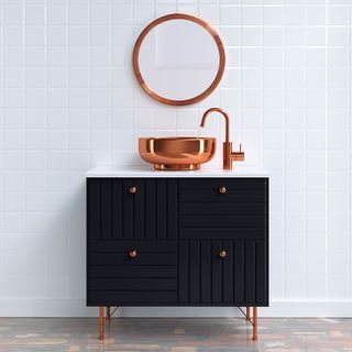 bathroom with white tiles wall and copper basin