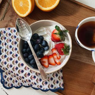 serving tray with strawberries and blueberry and spoon and coffee