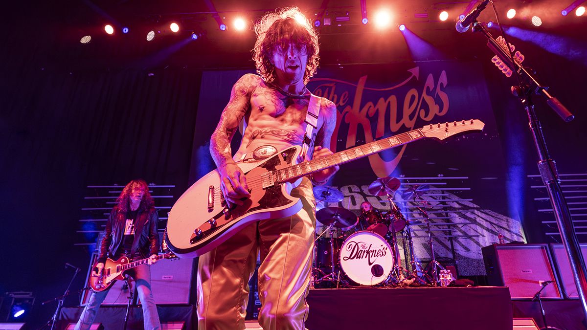 Justin Hawkins (front, center) and Dan Hawkins (background, left)