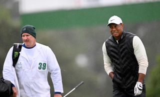 Tiger Woods walks alongside his caddie, Joe LaCava
