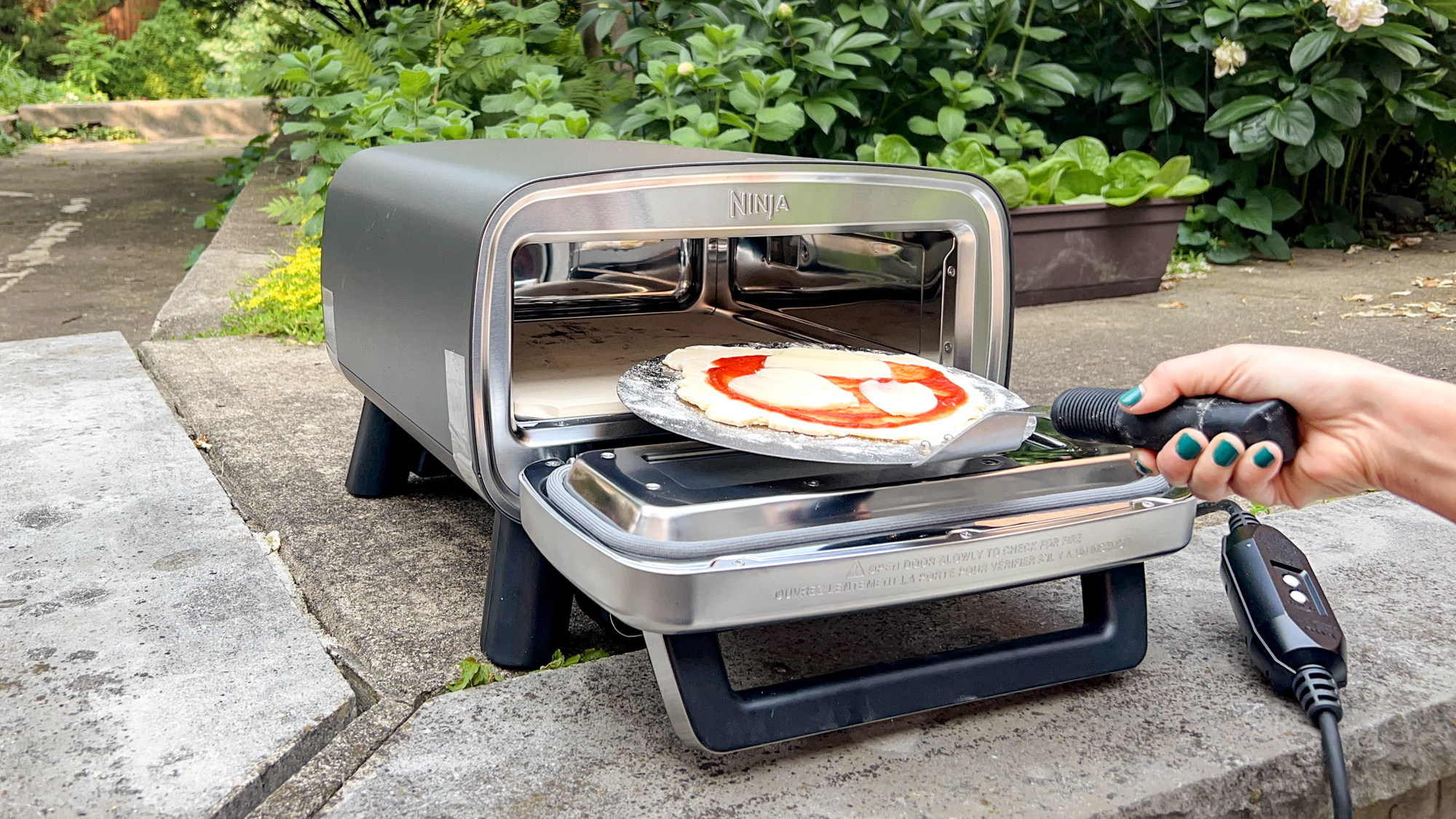 Ninja Artisan Outdoor Pizza Oven in a back yard