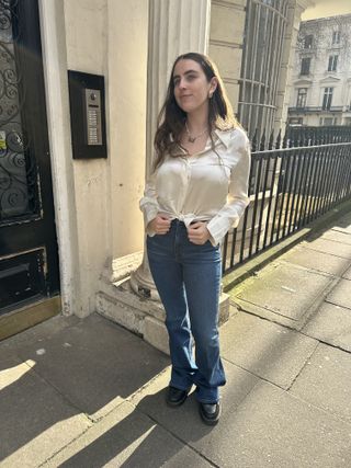 An image ofBest Knockoff Luxury Clothing
 UK SEO Writer Ava Gilchrist wearing the Veronica Beard flared jeans Megan Markle regularly wears.