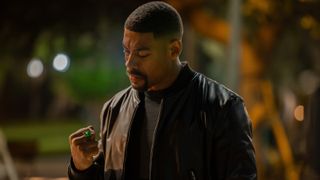 John Stewart looking at Hal Jordan's Green Lantern ring in Lanterns episode 8