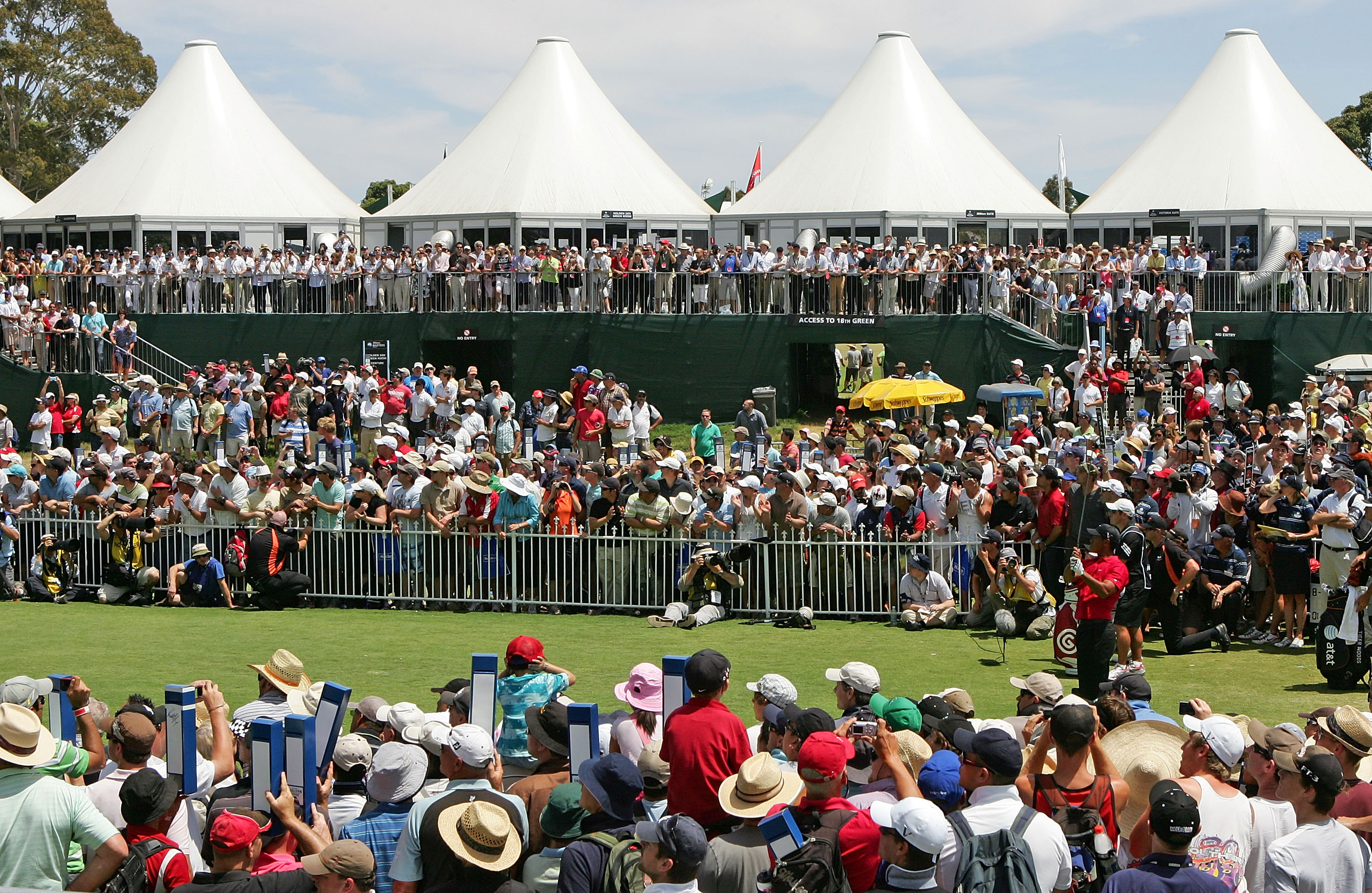 Tiger Woods hits a tee shot at the 2009 Australian Masters in front of a massive crowd at Kingston Heath