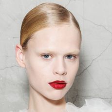 A model is seen backstage with super high shines hair at the Elisabetta Franchi fashion show during the Milan Womenswear Spring/Summer 2025