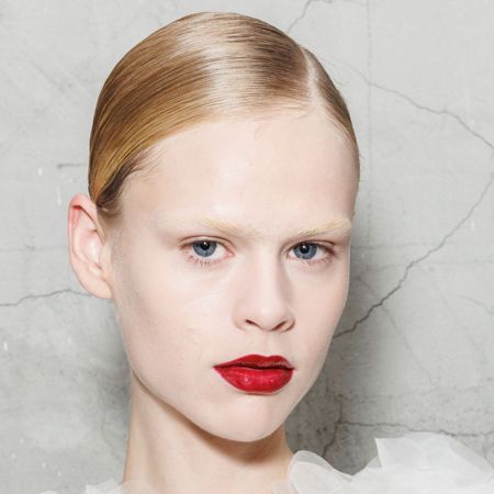 A model is seen backstage with super high shines hair at the Elisabetta Franchi fashion show during the Milan Womenswear Spring/Summer 2025