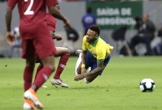 Neymar, right, is fouled in the friendly against Qatar