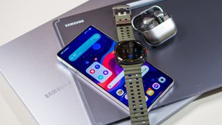 Samsung ecosystem of devices including the Galaxy S25 Ultra, Galaxy Watch Ultra, Buds 3 Pro, Samsung laptop, and Tab S10 Ultra