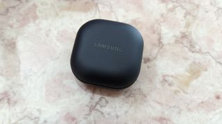 The Samsung Galaxy Buds 2 Pro's wireless charging case sitting atop a marble counter