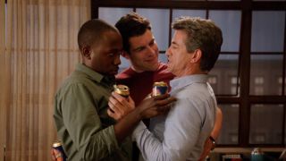 A screenshot of Winston, Schmidt and Russell all standing together, basically hugging, in Season 1 of New Girl.