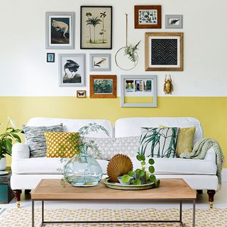living room with white sofa and wall photos