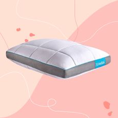A white Simba pillow with a blue branded label on apink background