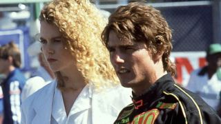 Nicole Kidman and Tom Cruise standing on the race track in Days of Thunder