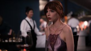 Anya Taylor-Joy sits shocked in her seat in The Menu.