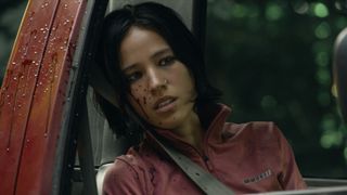 Iris sitting in a car with blood on her face as she looks out of the window in Don&#039;t Move.