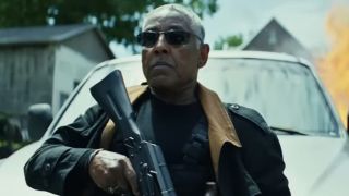 Giancarlo Esposito's Sidewinder holding a gun in front of a car in Captain America: Brave New World