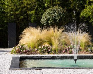 fountain in modern pond with gravel