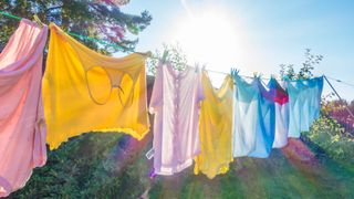 A washing line outside with clothes hanging to dry on it