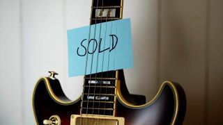 Electric guitar with sold sign 