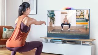 woman exercising in front of TV