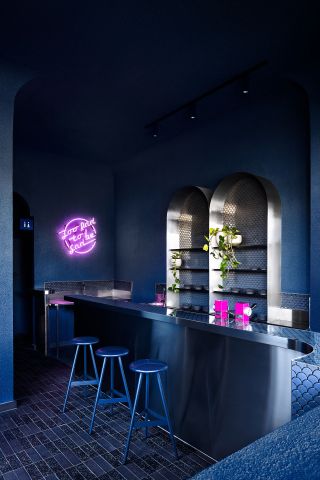 A cafe with blue lights and a blue wall