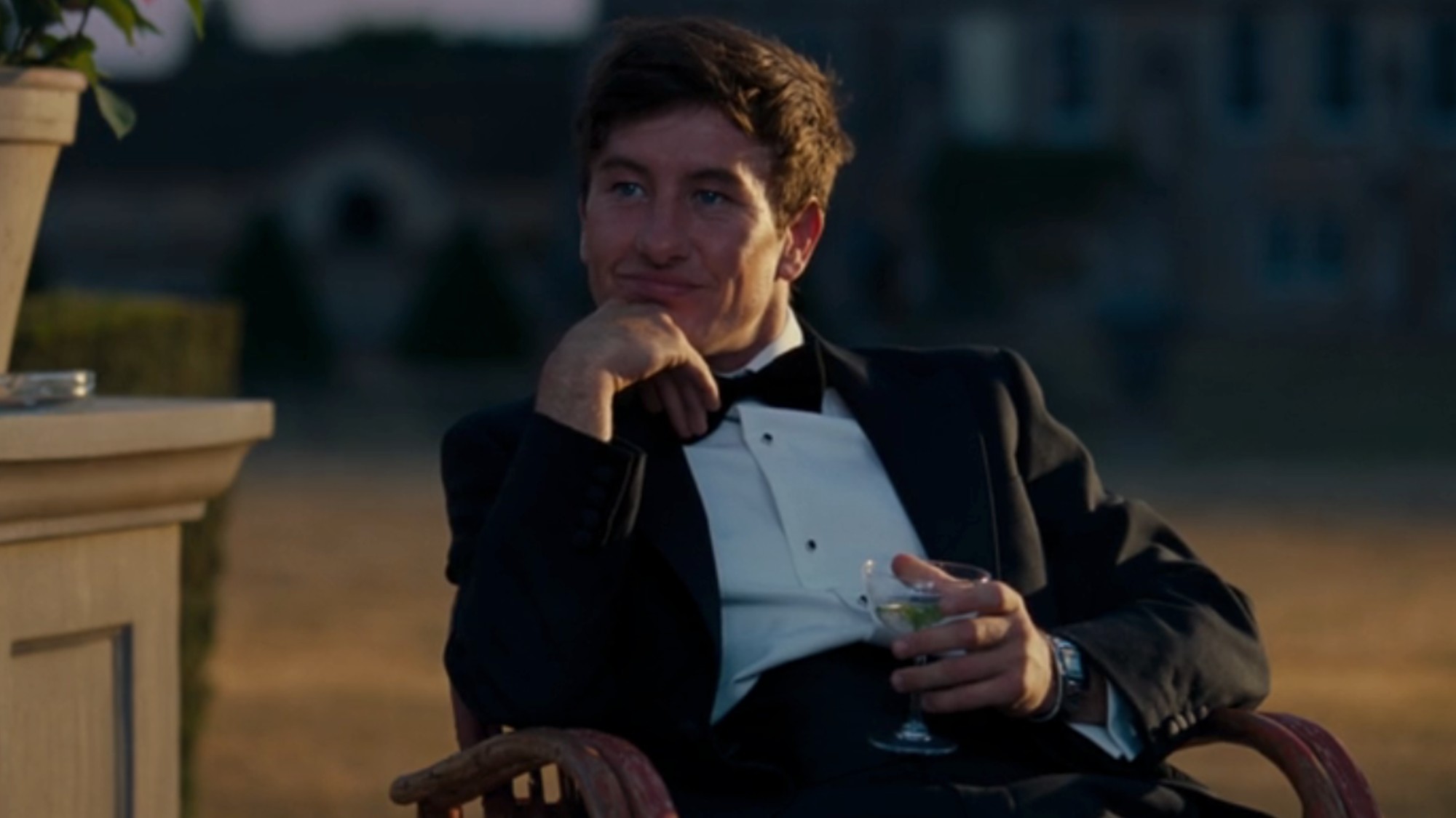 Barry Keoghan&amp;#8297; in a tuxedo, holding a martini in Saltburn