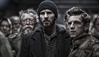 Snowpiercer John Hurt, Chris Evans, and Jamie Bell looking worried on board the train