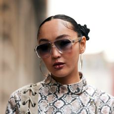 woman wearing glasses and pigtail buns with lipstick on