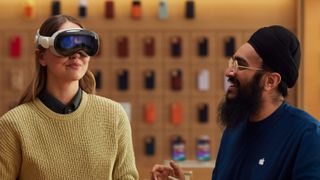 A woman experiencing an Apple Vision Pro demo next to an Apple employee