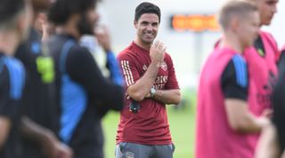 Arsenal manager Mikel Arteta smiles during a training session