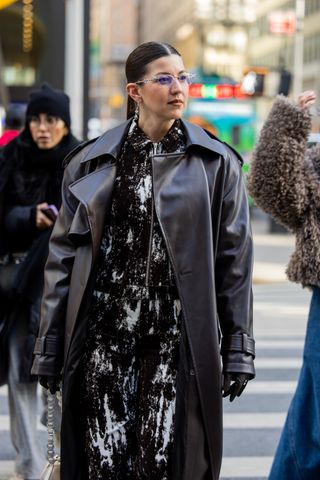 A guest wears a black duster jacket during New York Fashion Week's Fall/Winter 2025 shows