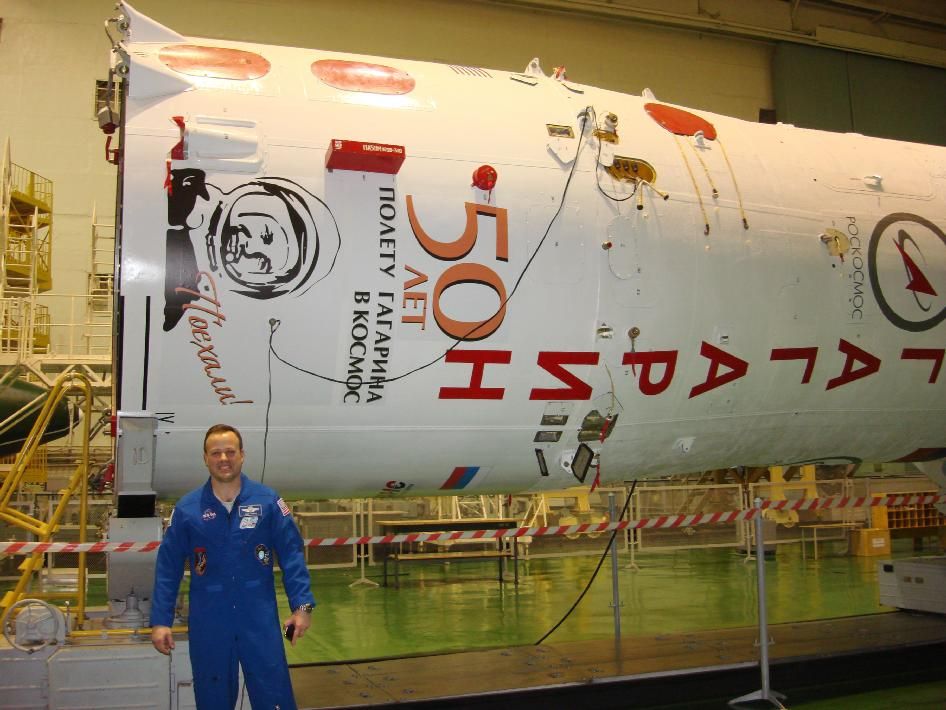 NASA astronaut Ron Garan poses in front of the booster for the Yuri Gagarin Soyuz spacecraft that will carry him and two Russian cosmonauts to the International Space Station.