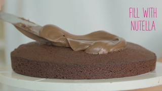 Covering a chocolate finger cake with Nutella