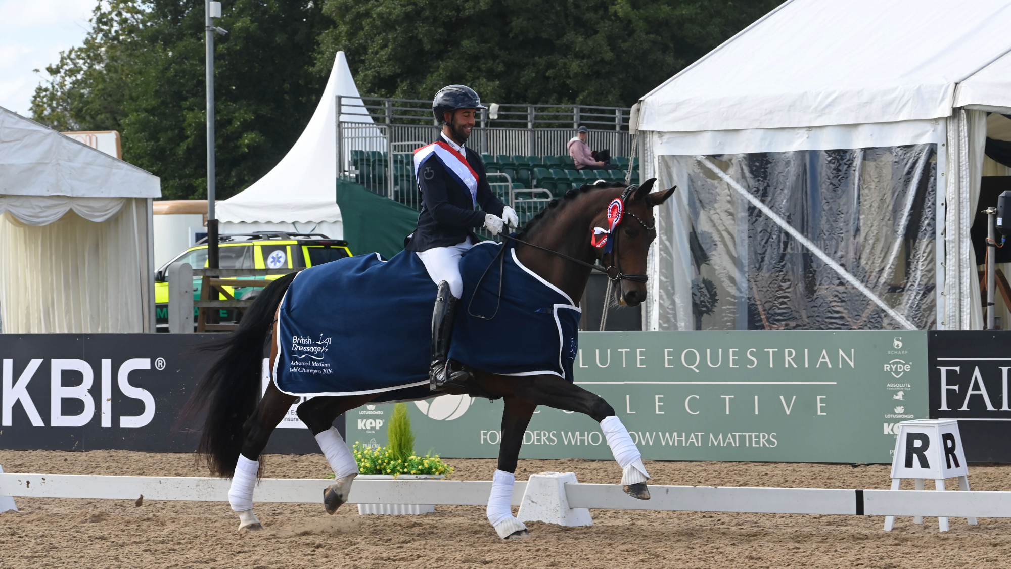 Dannie Morgan rides Freya VII in trot, wearing the British Dressage Advanced Medium Gold Champion 2026 rug, at the LeMieux National Dressage Championships.