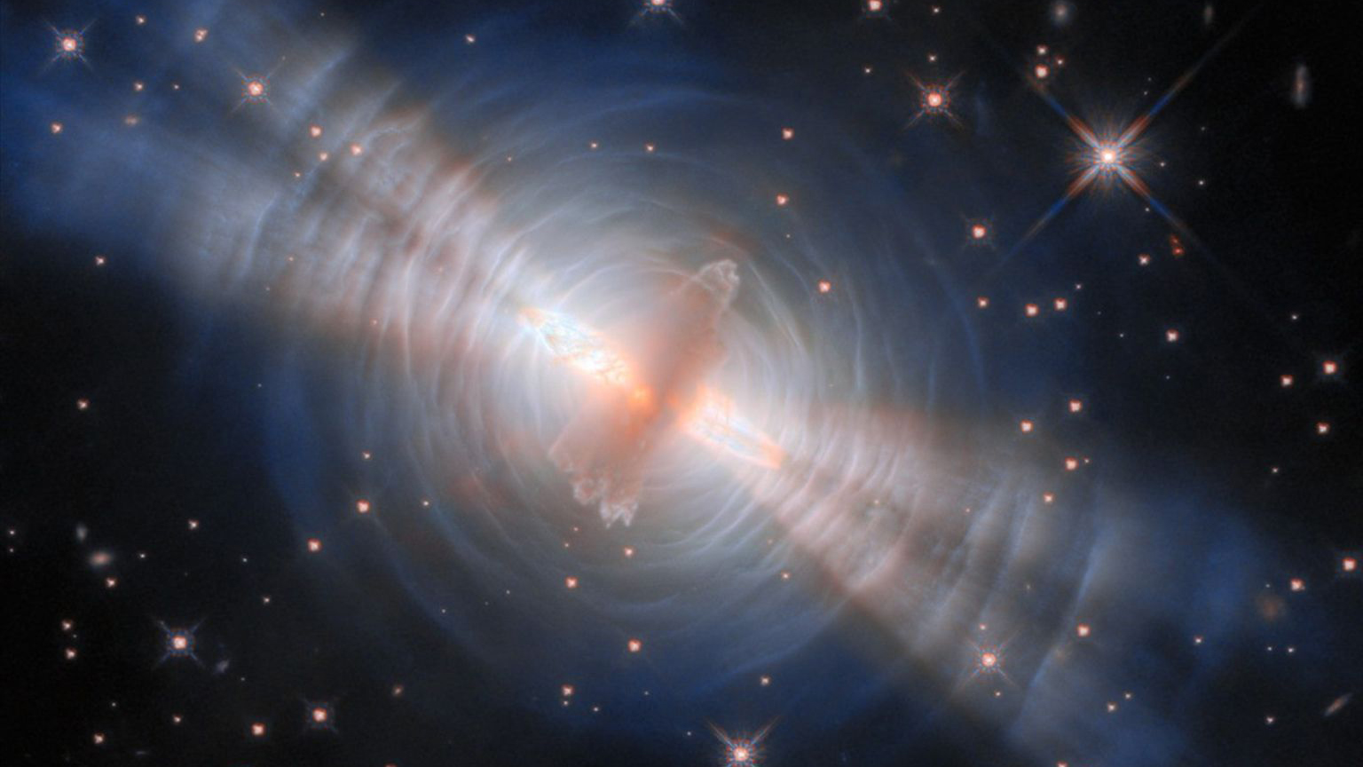 A photograph of the Egg Nebula, a pre-planetary nebula, captured by he Hubble Space Telescope