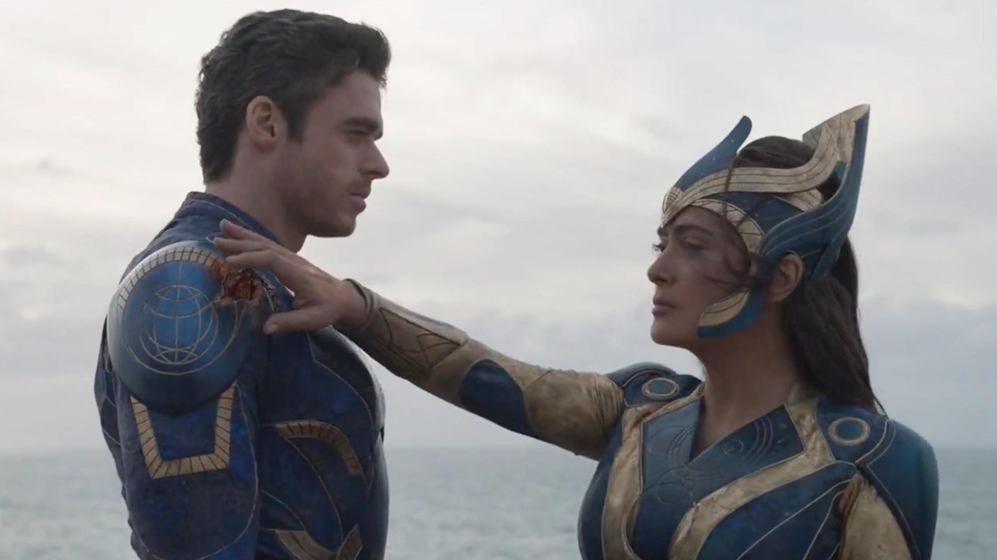 Selma Hayek with her hand on Richard Madden's shoulder in Eternals