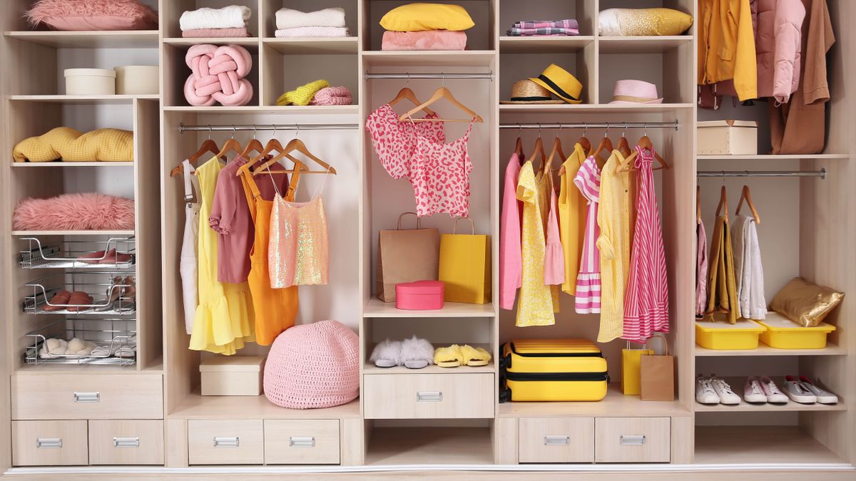 An organised wardrobe filled with clothes and shoes