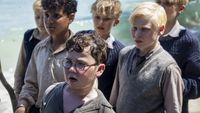 David McKenna (front) as Piggy is shown with other boys in Lord of the Flies.