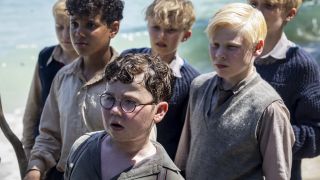 David McKenna (front) as Piggy is shown with other boys in Lord of the Flies.