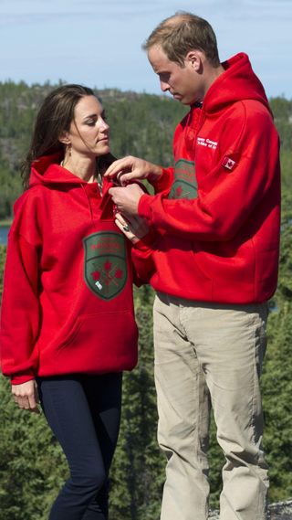The Prince and Princess of Wales wearing matching hoodies on their honeymoon tour of Canada in 2011.