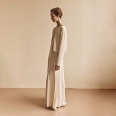 Model wearing a white floor length dress sold at Ghost