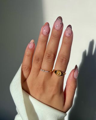 Iram Shelton with neutral hue French tip manicure trend
