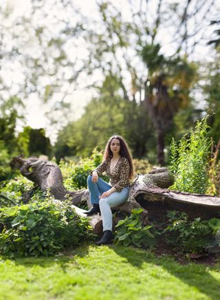 A portrait of a woman in a green space, captured using the Brenizer method