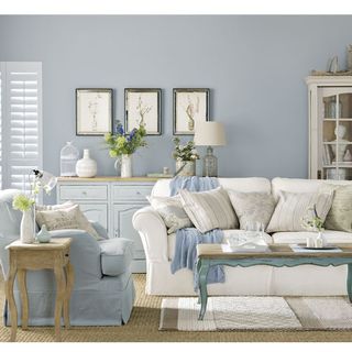 living room with grey walls and sofa white cushions